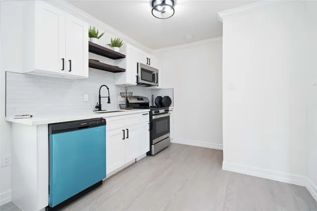 a kitchen with a sink a stove and cabinets