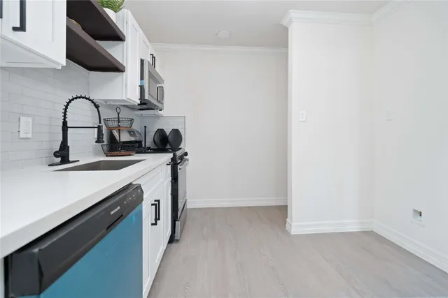 a kitchen with stainless steel appliances a stove microwave and cabinets