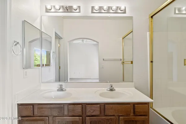 a bathroom with a shower sink vanity and mirror