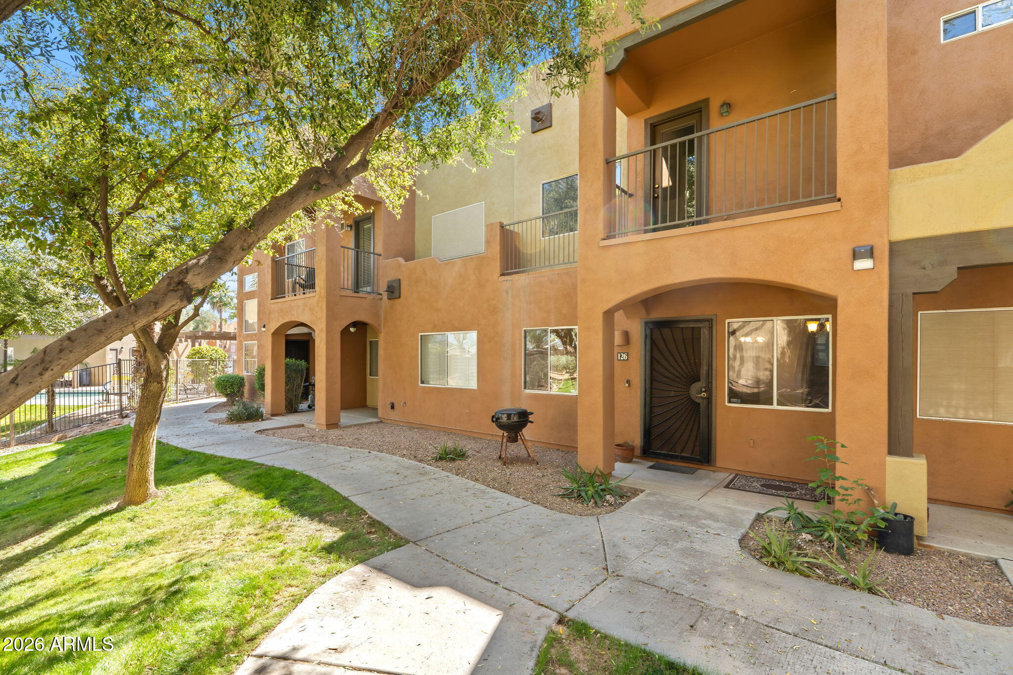 1718 West Colter Street, Unit 126 Phoenix, AZ 85015 - Photo 2 of 29 a front view of a house with a yard