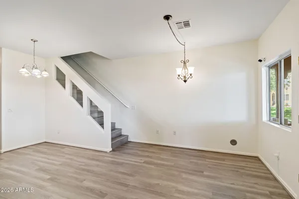 a view of a hallway with wooden floor and staircase