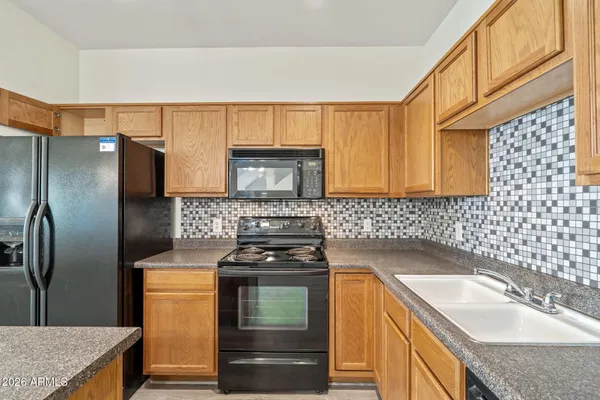 a kitchen with a sink stove and refrigerator