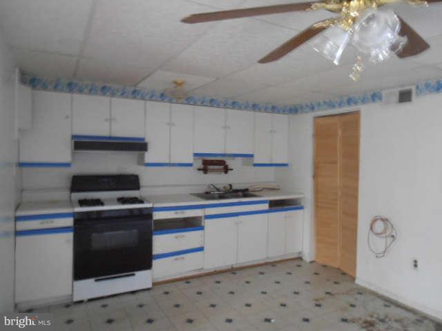 2022 Larkhall Road Dundalk, MD 21222 - Photo 2 of 10 a kitchen with stainless steel appliances a stove a sink and a refrigerator