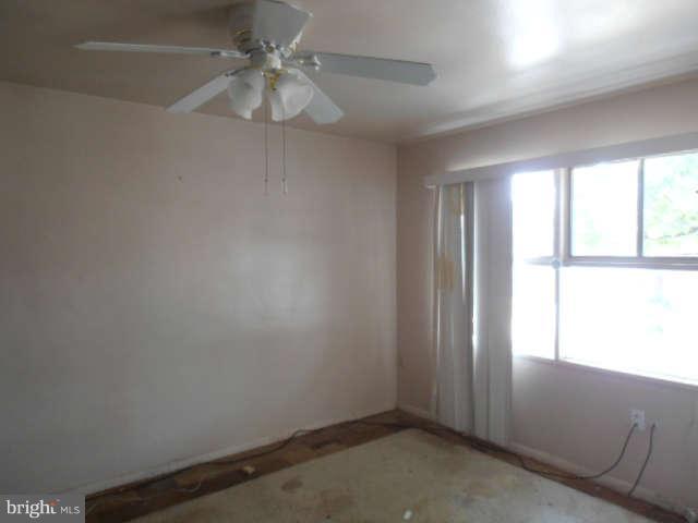 2022 Larkhall Road Dundalk, MD 21222 - Photo 8 of 10 an empty room with a window and a fan