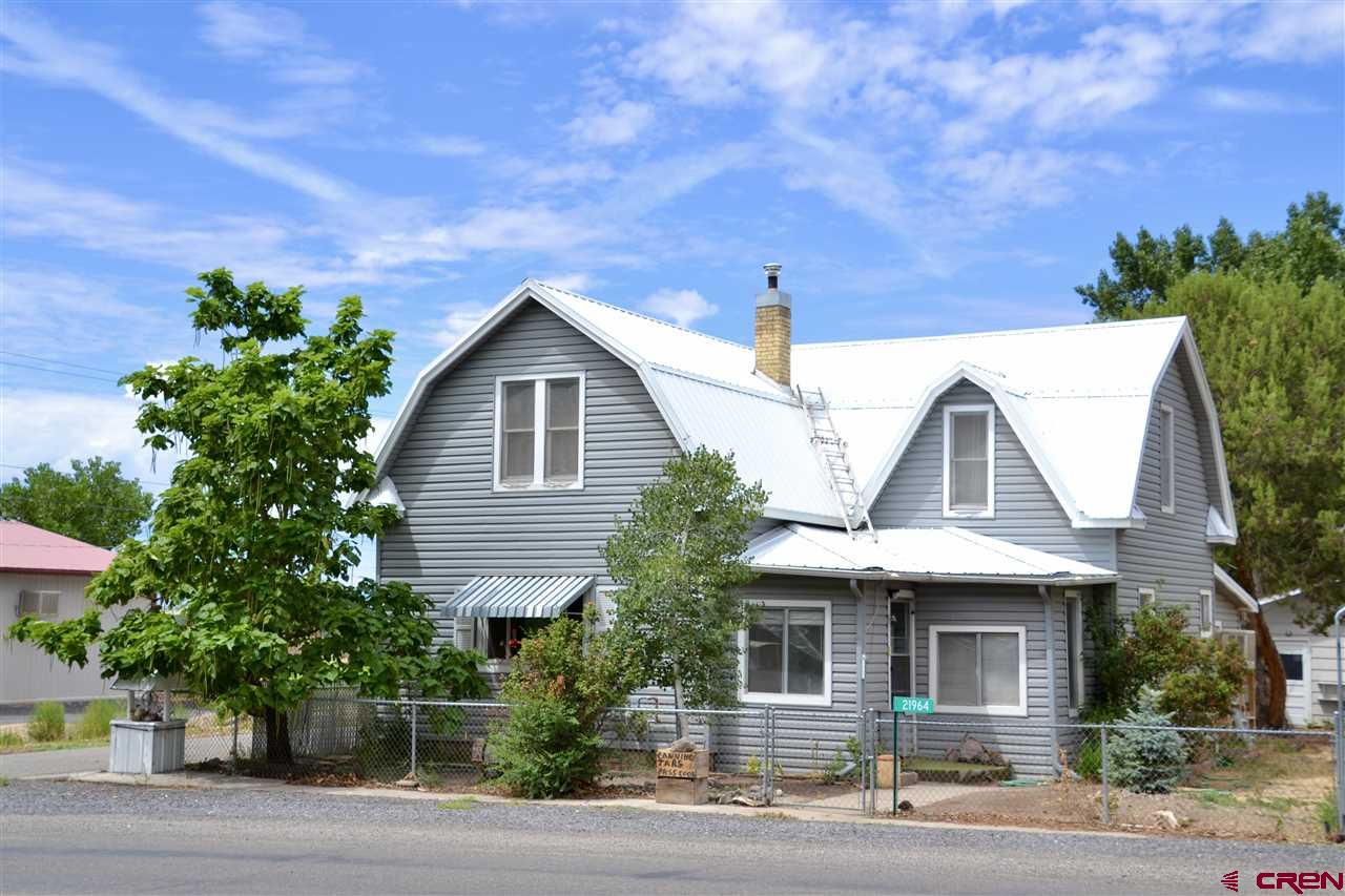 21964 Austin Road Austin, CO 81410 - Photo 1 of 33 a front view of a house with a garden