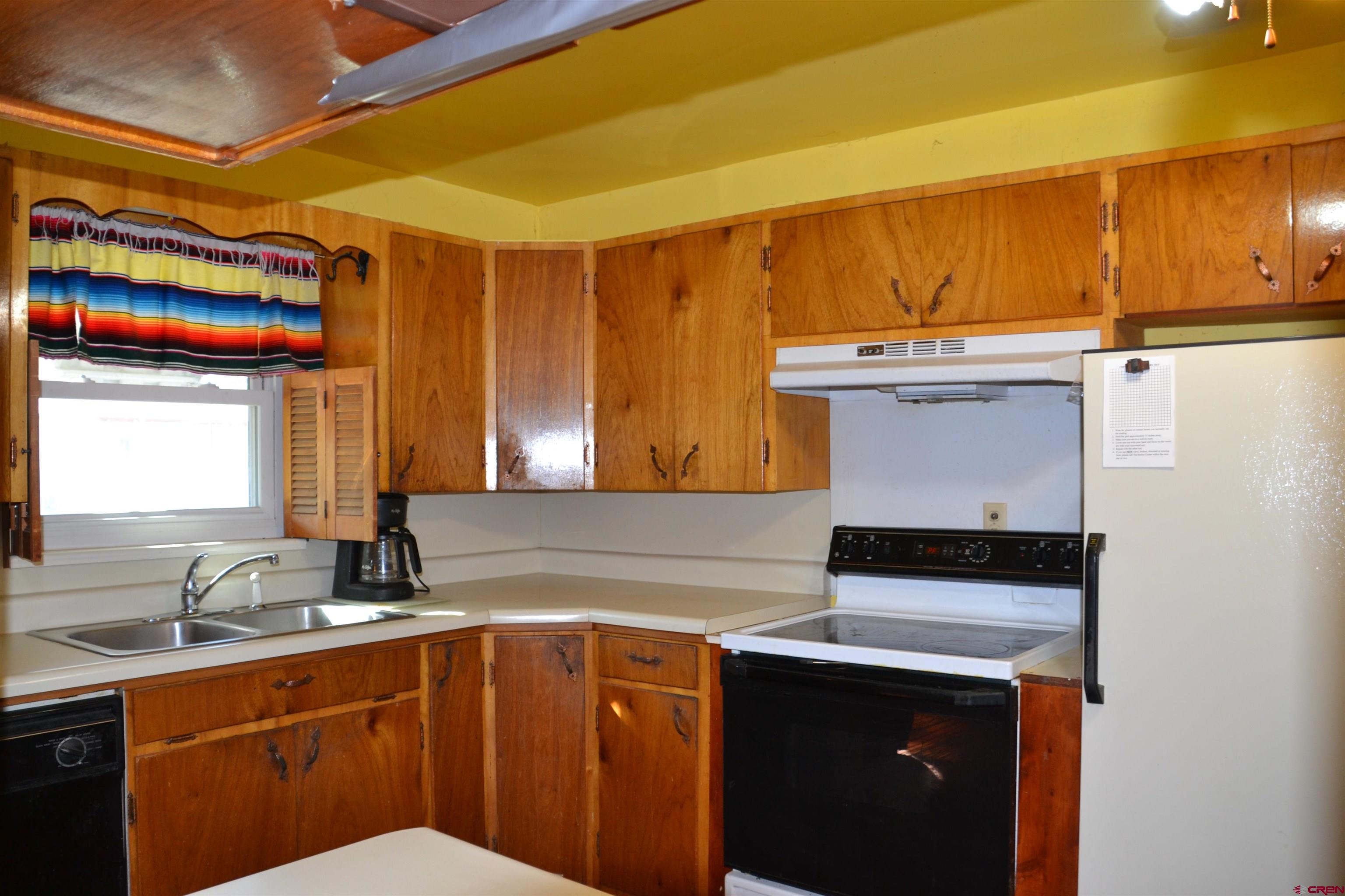 21964 Austin Road Austin, CO 81410 - Photo 11 of 33 a kitchen with a sink a stove and cabinets