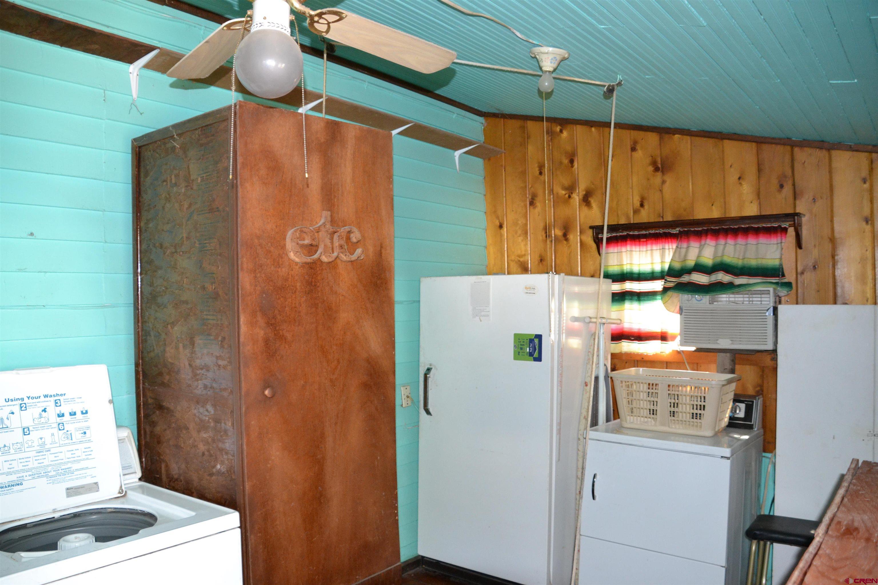 21964 Austin Road Austin, CO 81410 - Photo 17 of 33 a white refrigerator freezer and a table