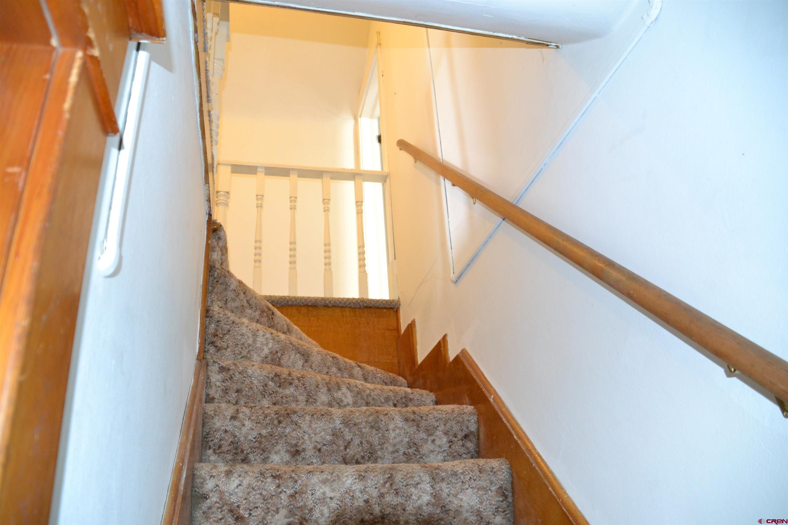 21964 Austin Road Austin, CO 81410 - Photo 19 of 33 a view of staircase with railing and door
