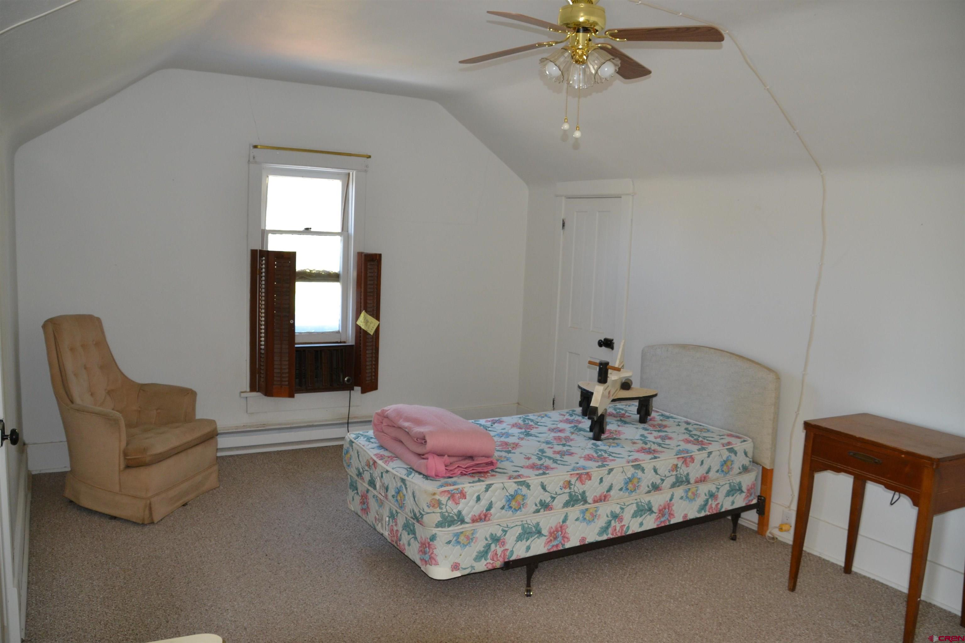 21964 Austin Road Austin, CO 81410 - Photo 24 of 33 a bedroom with a bed and window