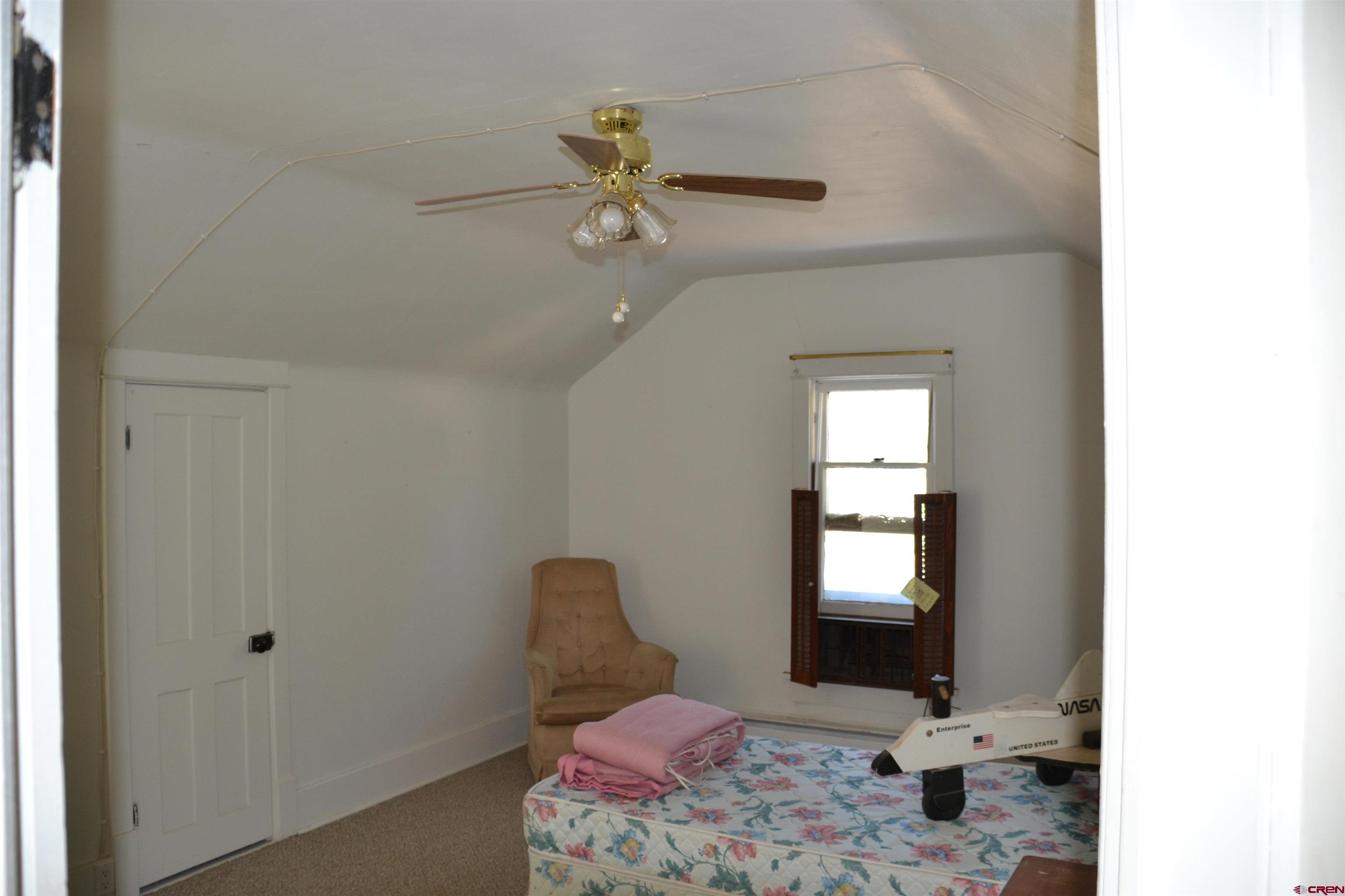 21964 Austin Road Austin, CO 81410 - Photo 25 of 33 a view of a livingroom with a chandelier fan and windows