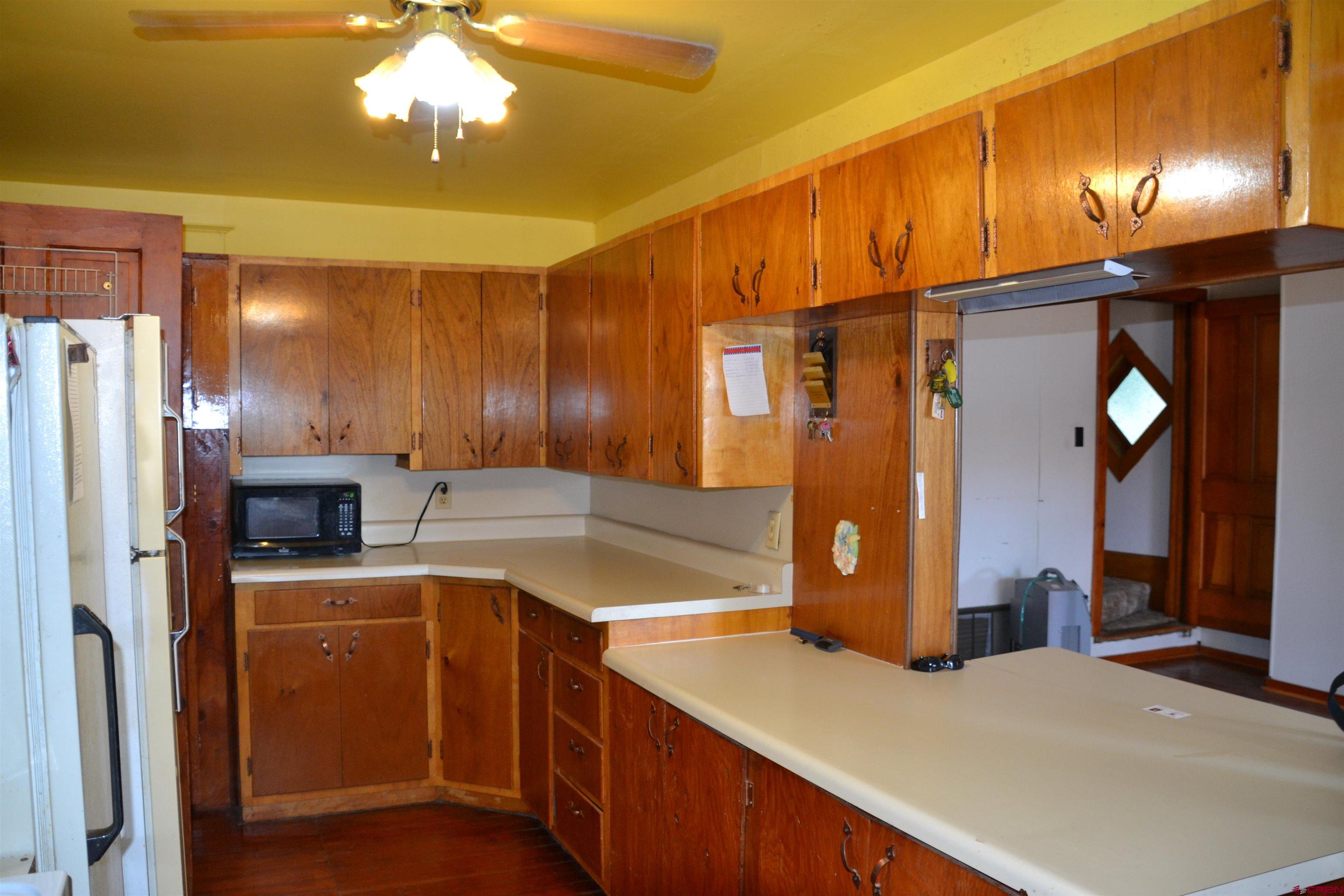 21964 Austin Road Austin, CO 81410 - Photo 10 of 33 a kitchen with a sink appliances and cabinets