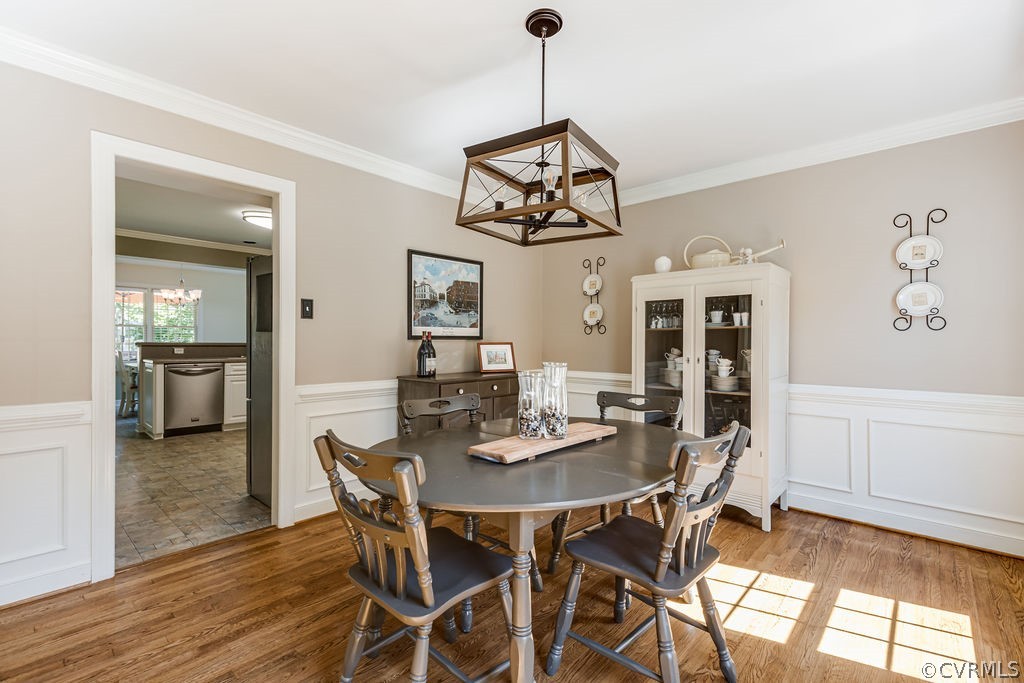 5311 Meadow Chase Road Midlothian, VA 23112 - Photo 14 of 49 a view of a dining room and livingroom with furniture wooden floor a chandelier