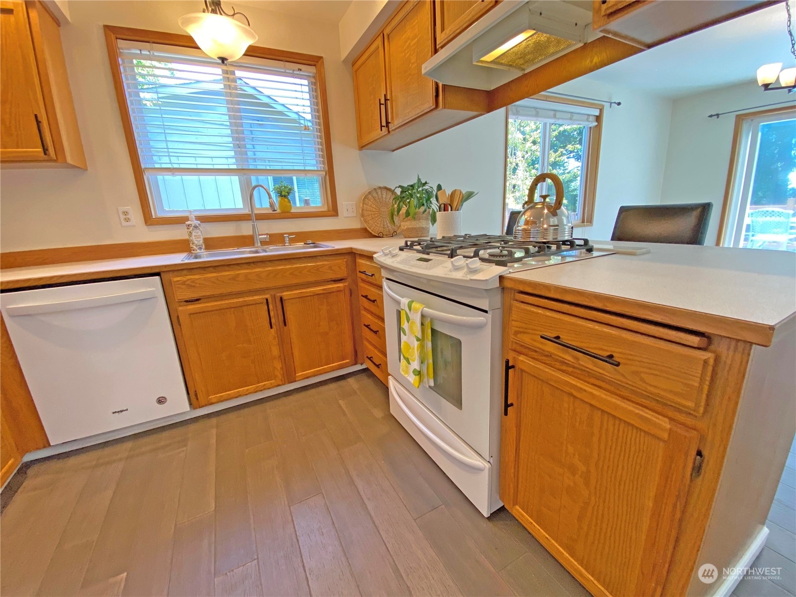 1804 224th Street Southwest Bothell, WA 98021 - Photo 8 of 31 a kitchen with stainless steel appliances granite countertop a sink and wooden cabinets