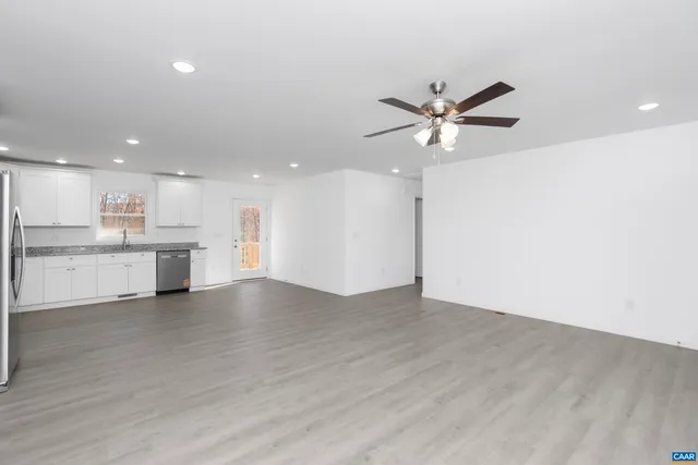 a view of kitchen with microwave and cabinets