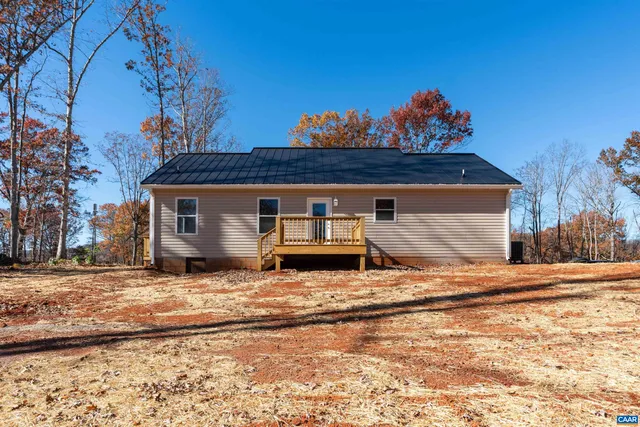 an empty room with wooden floor and ceiling fan