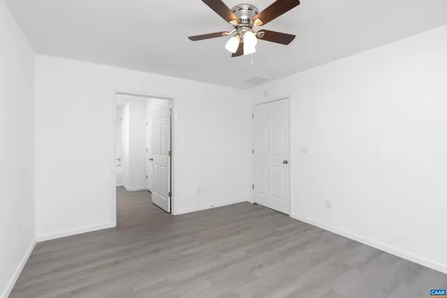 a bathroom with a granite countertop sink a toilet and a mirror