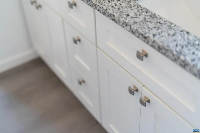 an empty room with a window and a ceiling fan