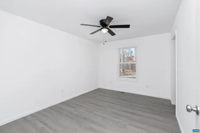 a bathroom with a granite countertop sink a toilet and bathtub