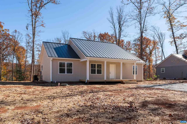 a view of a house with a yard covered in snow