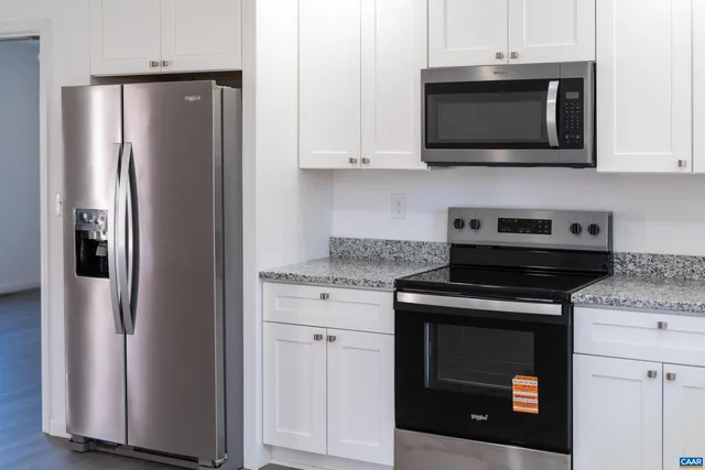 a kitchen with stainless steel appliances wooden cabinets and a stove top oven
