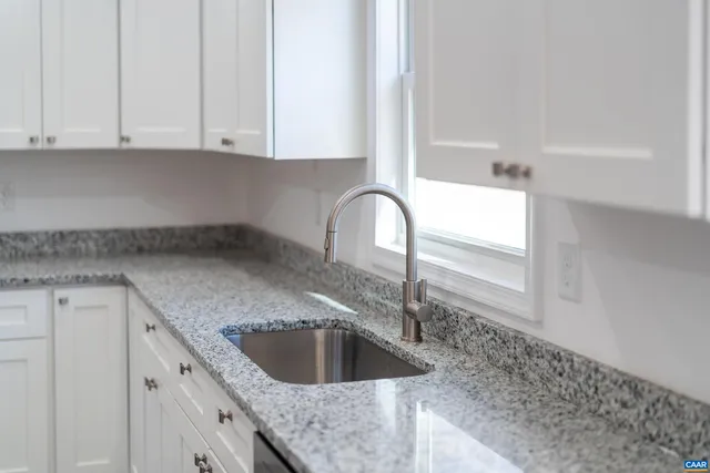 a view of a kitchen with a sink and a chandelier