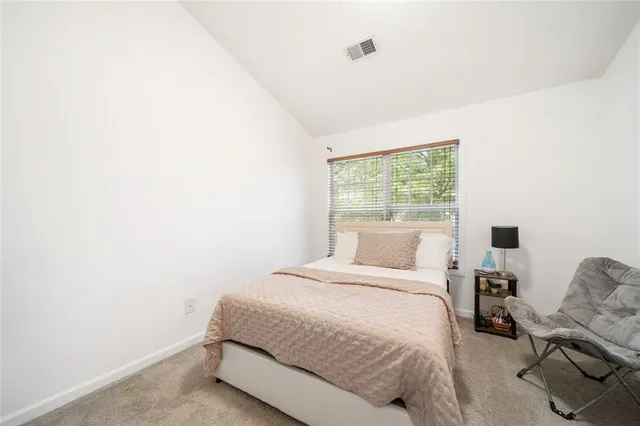 a bedroom with a bed and window