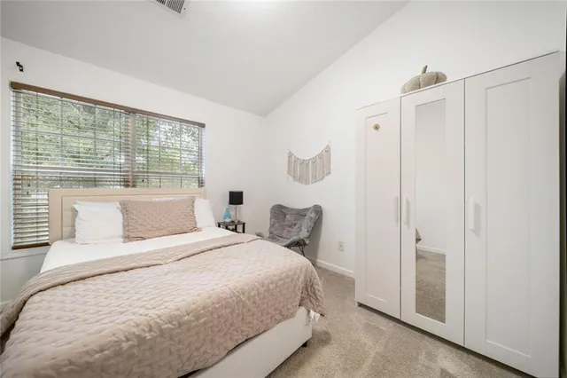 a bedroom with a bed and a large window