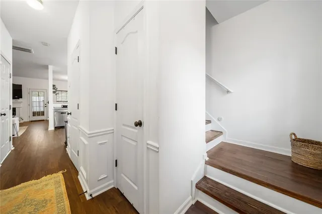 a large white kitchen with a stove a sink a dining table and chairs
