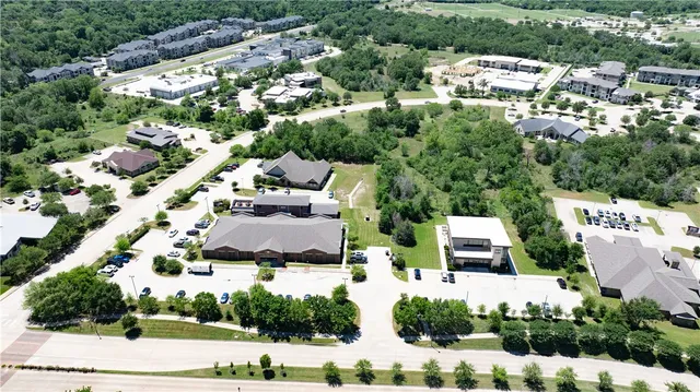 an aerial view of residential houses with outdoor space and street view
