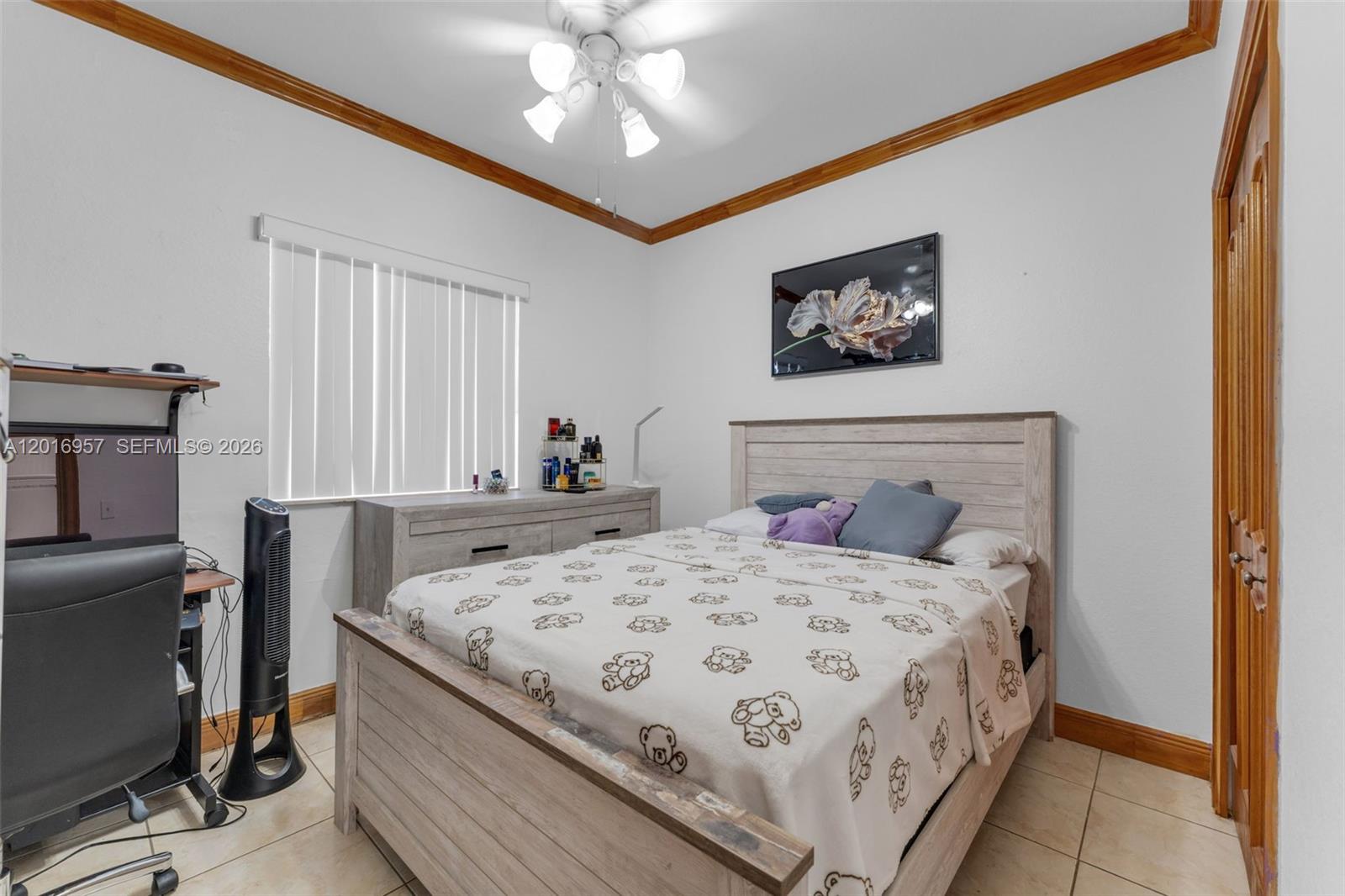 12266 Southwest 215th Terrace Miami, FL 33177 - Photo 11 of 29 a bedroom with a bed and a chandelier