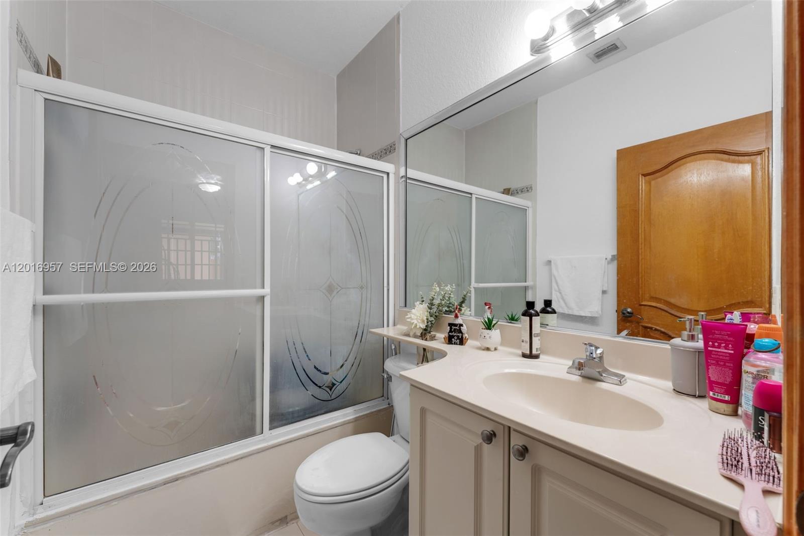 12266 Southwest 215th Terrace Miami, FL 33177 - Photo 17 of 29 a bathroom with a sink toilet and shower
