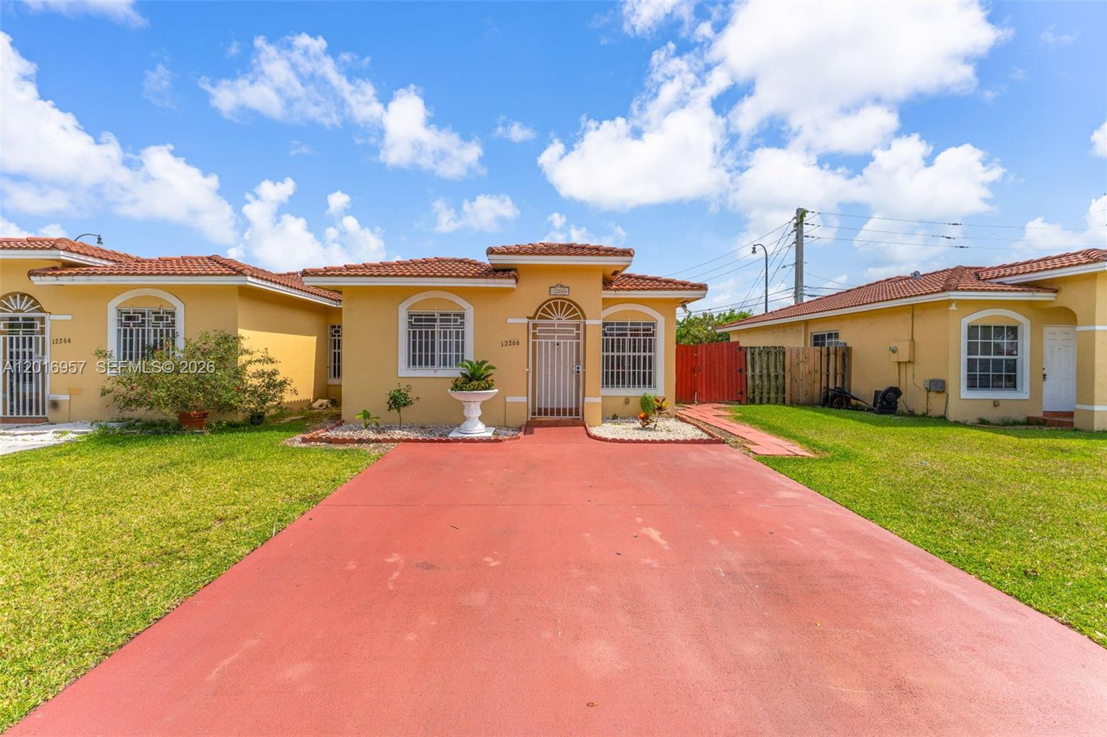 12266 Southwest 215th Terrace Miami, FL 33177 - Photo 2 of 29 a front view of house with yard and green space