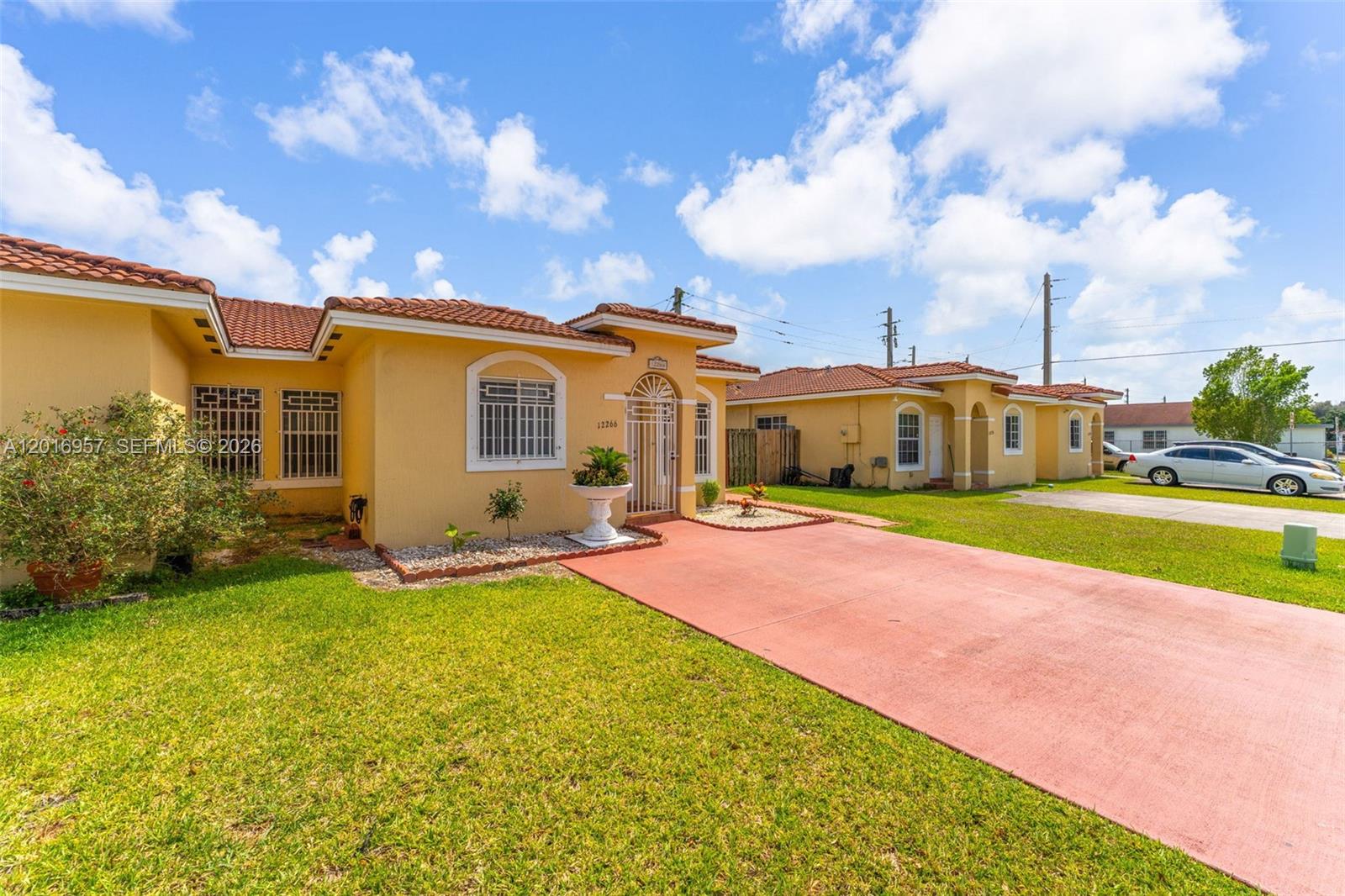 12266 Southwest 215th Terrace Miami, FL 33177 - Photo 3 of 29 a view of a house with swimming pool and a yard