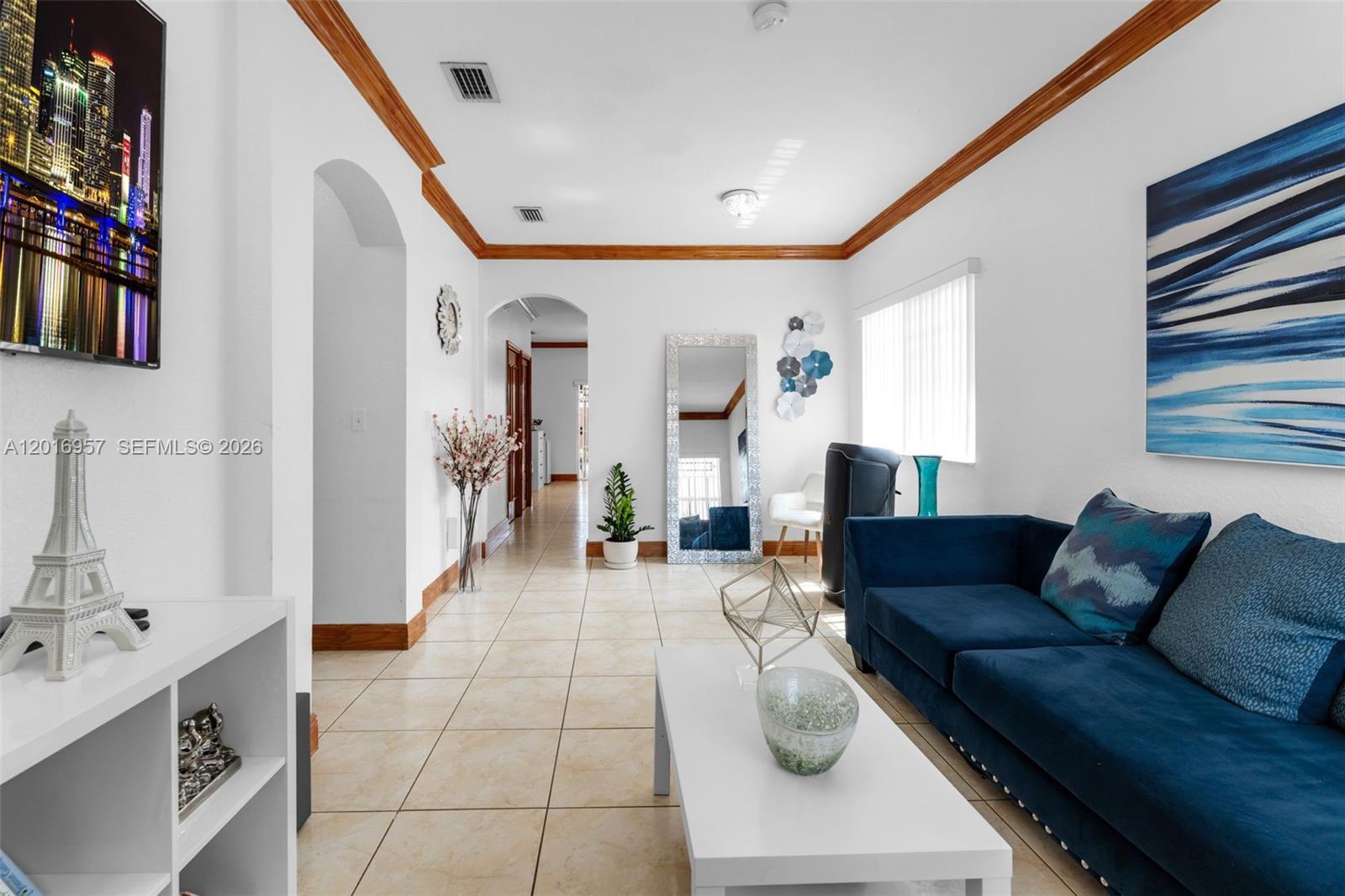 12266 Southwest 215th Terrace Miami, FL 33177 - Photo 6 of 29 a living room with furniture and a flat screen tv