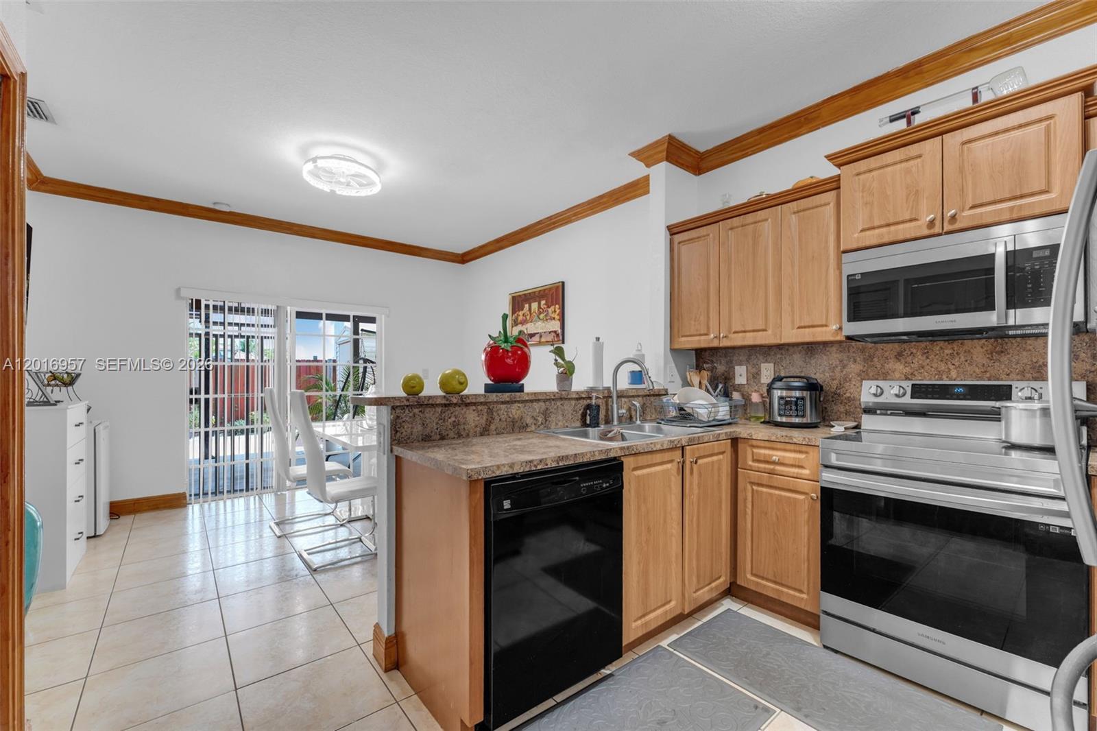 12266 Southwest 215th Terrace Miami, FL 33177 - Photo 7 of 29 a kitchen with a stove and a microwave