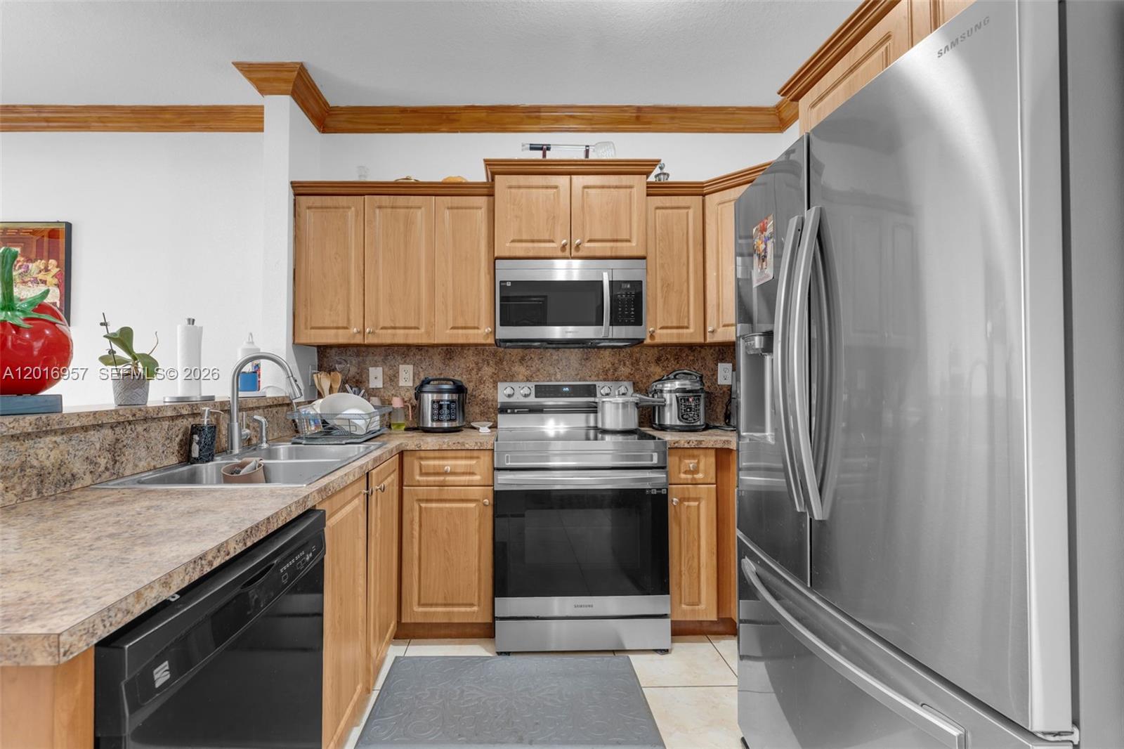 12266 Southwest 215th Terrace Miami, FL 33177 - Photo 8 of 29 a kitchen with stainless steel appliances granite countertop a refrigerator stove and sink