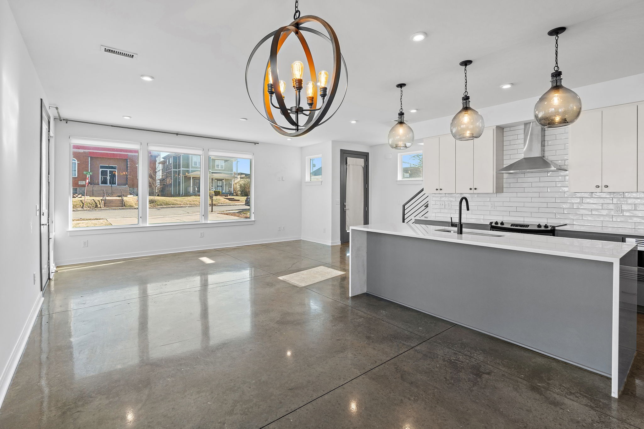 1925 10th Avenue North Nashville, TN 37208 - Photo 14 of 40 a large kitchen with a large window and a chandelier