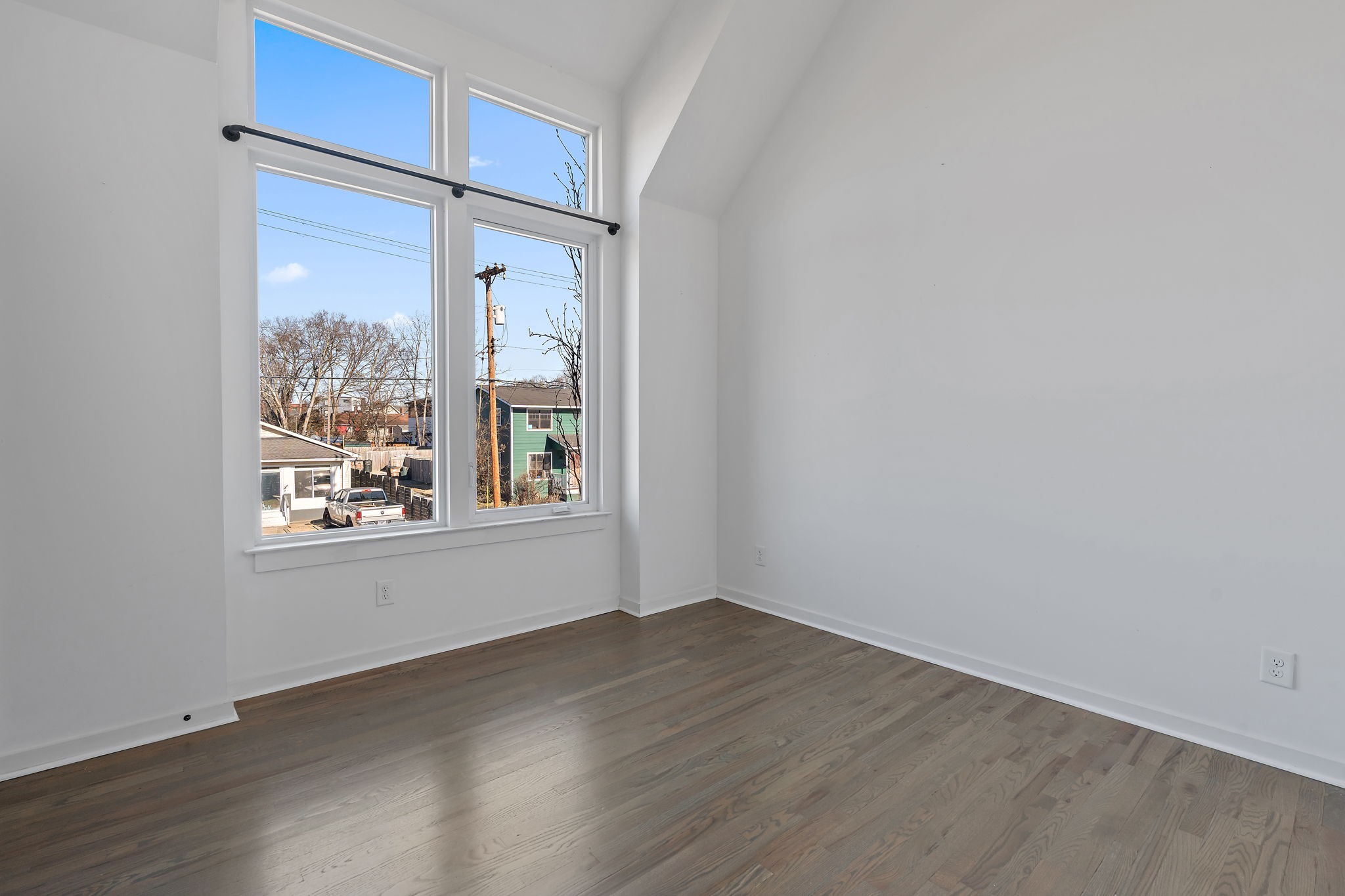 1925 10th Avenue North Nashville, TN 37208 - Photo 29 of 40 a view of an empty room with wooden floor and a window