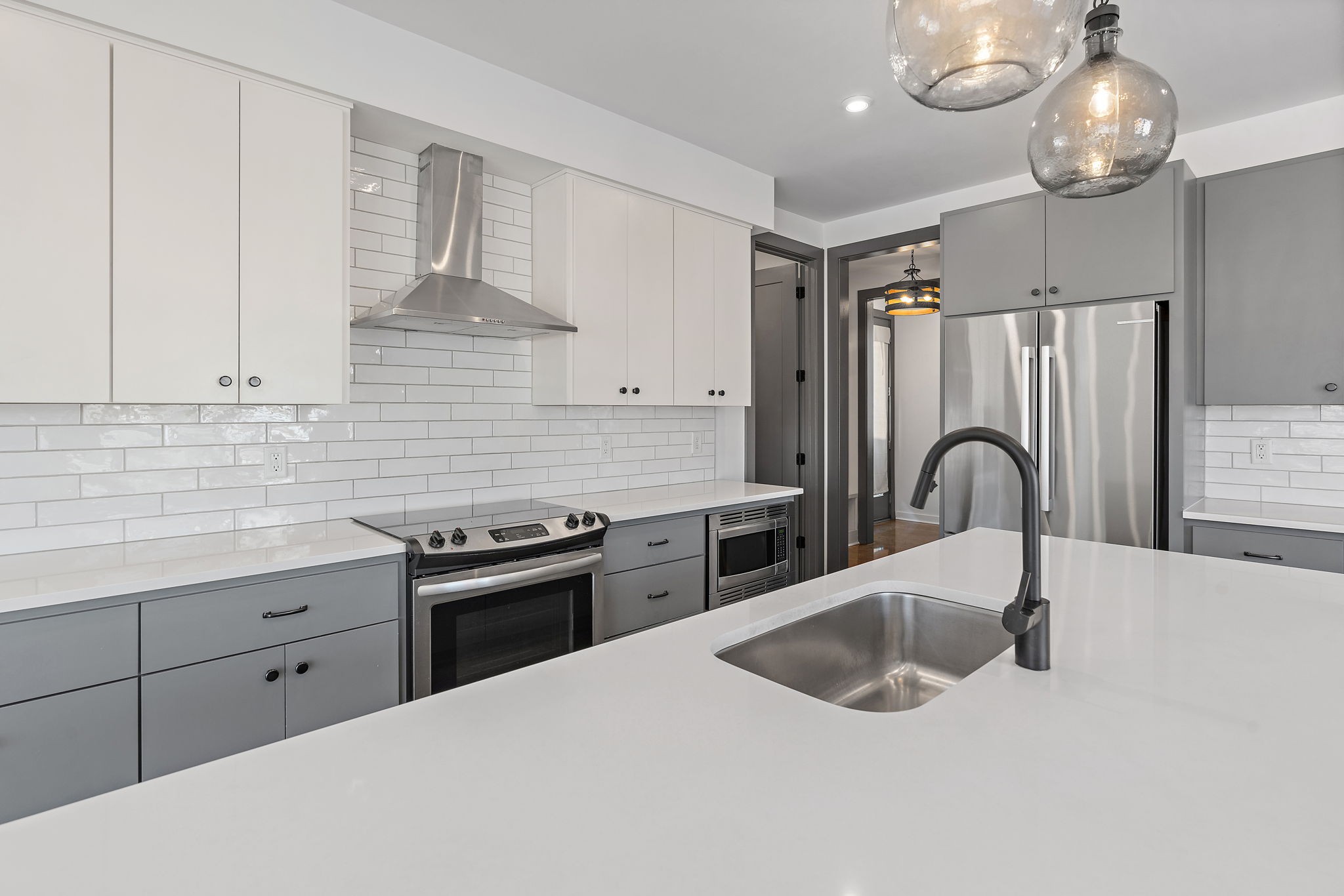 1925 10th Avenue North Nashville, TN 37208 - Photo 7 of 40 a kitchen with kitchen island granite countertop a sink stainless steel appliances and cabinets