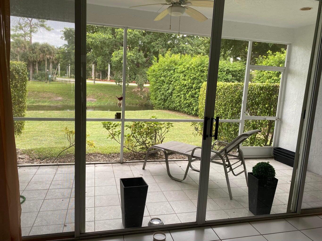 21530 St Andrews Grand Circle, Unit 27 Boca Raton, FL 33486 - Photo 1 of 17 a view of a floor to ceiling window and an outdoor view