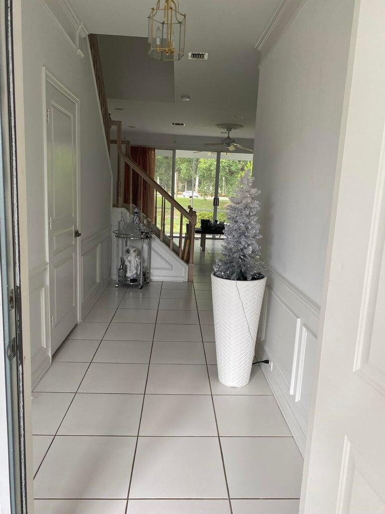 21530 St Andrews Grand Circle, Unit 27 Boca Raton, FL 33486 - Photo 6 of 17 a view of a room with a large window and chandelier