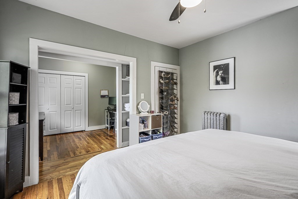 10 Worsted Street Franklin, MA 02038 - Photo 13 of 28 a bedroom with a large bed and a chandelier