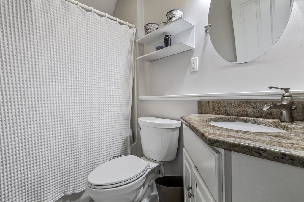 10 Worsted Street Franklin, MA 02038 - Photo 15 of 28 a bathroom with a granite countertop toilet sink and mirror