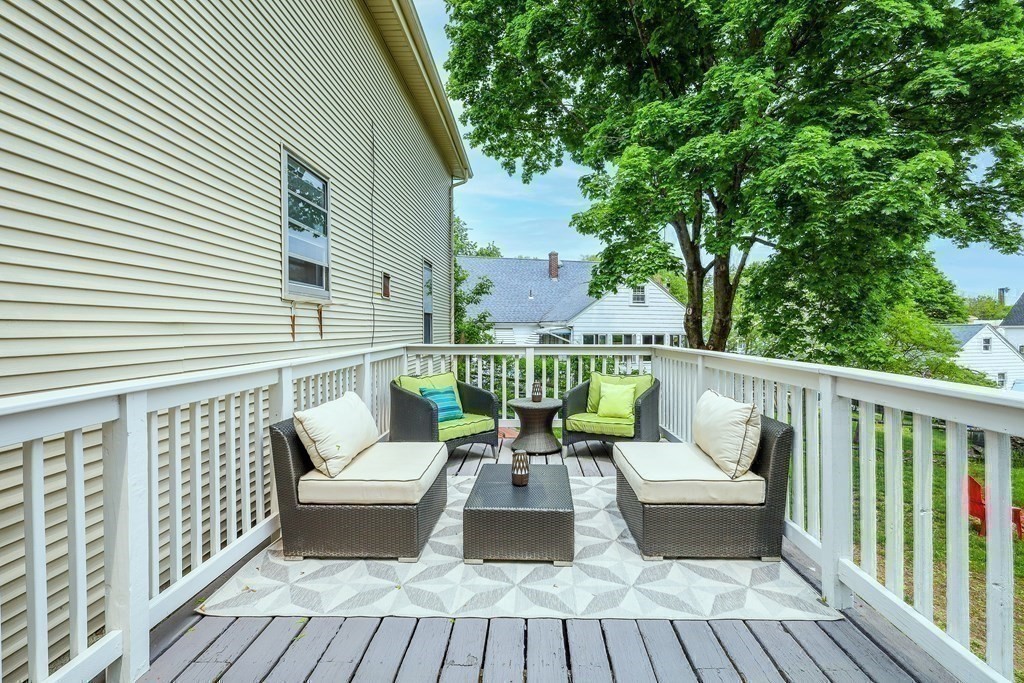 10 Worsted Street Franklin, MA 02038 - Photo 20 of 28 a balcony with wooden floor table and chairs