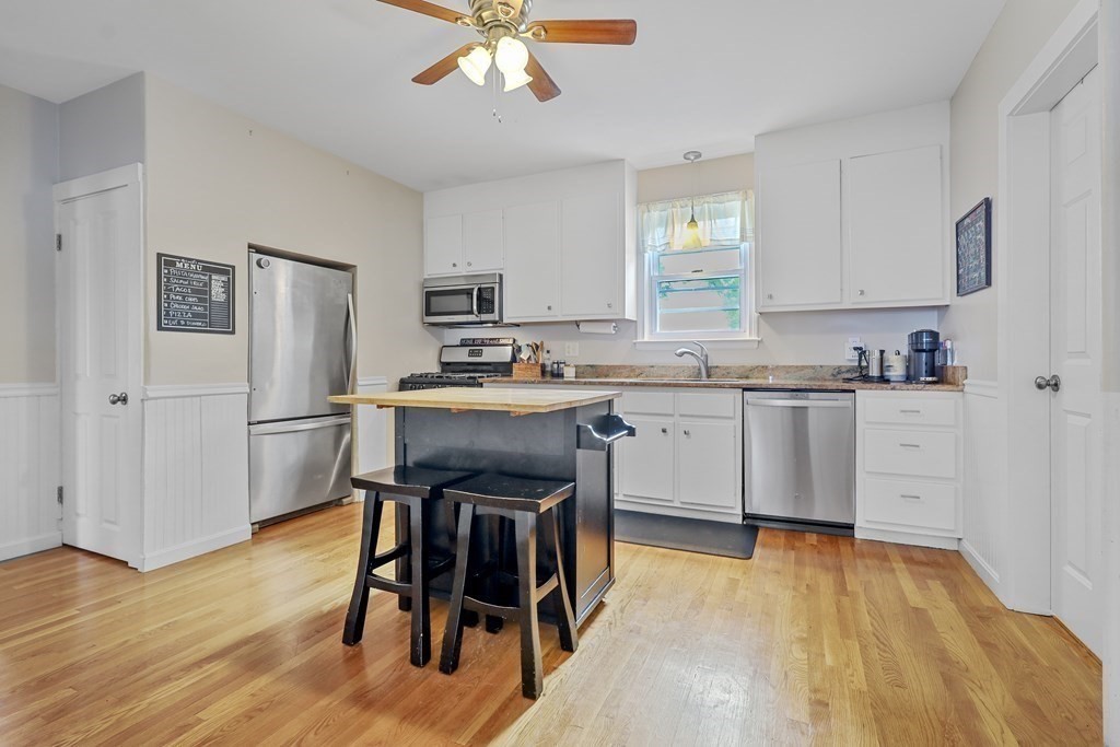 10 Worsted Street Franklin, MA 02038 - Photo 2 of 28 a kitchen with stainless steel appliances a table chairs refrigerator and a sink