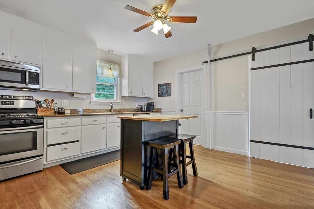 10 Worsted Street Franklin, MA 02038 - Photo 3 of 28 a kitchen with a table chairs refrigerator and cabinets