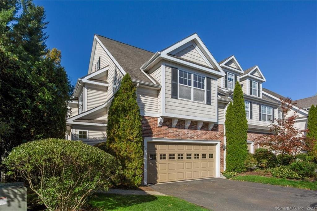 90 Goodwin Circle, Unit 90 Hartford, CT 06105 - Photo 1 of 1 a front view of a house with a yard and potted plants