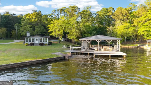 a white house with a large pool