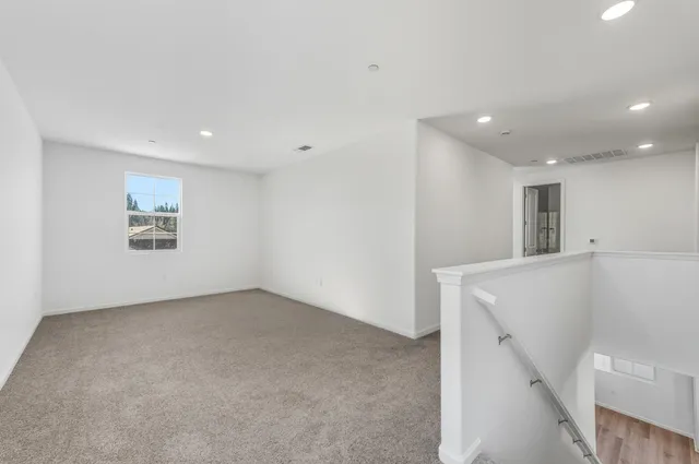 a view of an empty room with windows