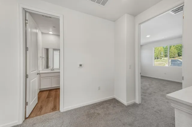 an empty room with windows and closet